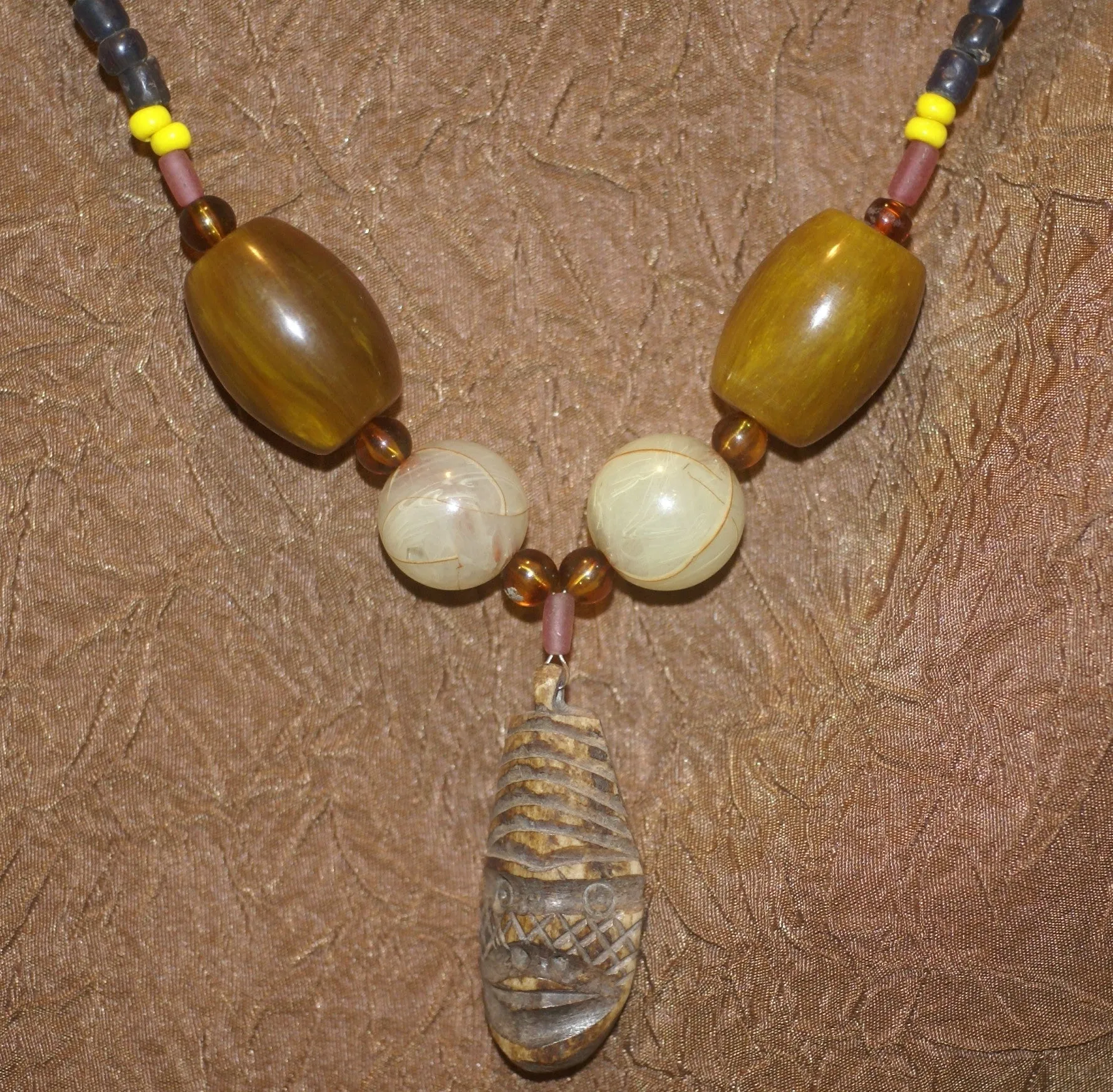 Unique Earthtones Hand crafted Ethnic Glass Trade Beads Necklace with Buffalo Bone Hand Carved Pendant of Protective Ancestor for Good Luck, Borneo Kalimantan, Indonesia NECK32   1 Flapper Coconut necklace.