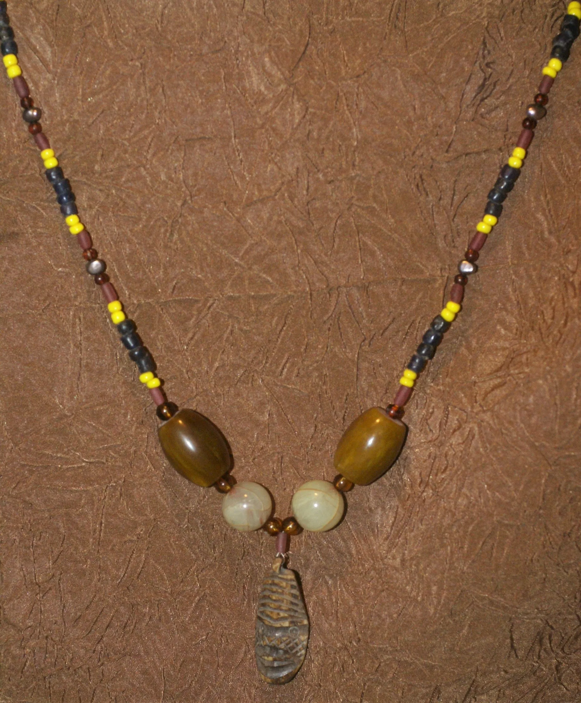 Unique Earthtones Hand crafted Ethnic Glass Trade Beads Necklace with Buffalo Bone Hand Carved Pendant of Protective Ancestor for Good Luck, Borneo Kalimantan, Indonesia NECK32   1 Flapper Coconut necklace.