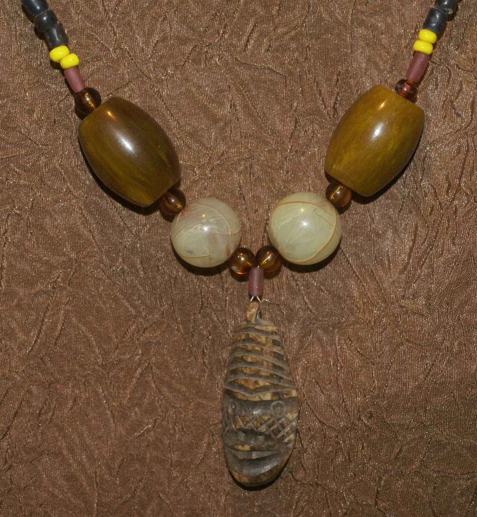 Unique Earthtones Hand crafted Ethnic Glass Trade Beads Necklace with Buffalo Bone Hand Carved Pendant of Protective Ancestor for Good Luck, Borneo Kalimantan, Indonesia NECK32   1 Flapper Coconut necklace.